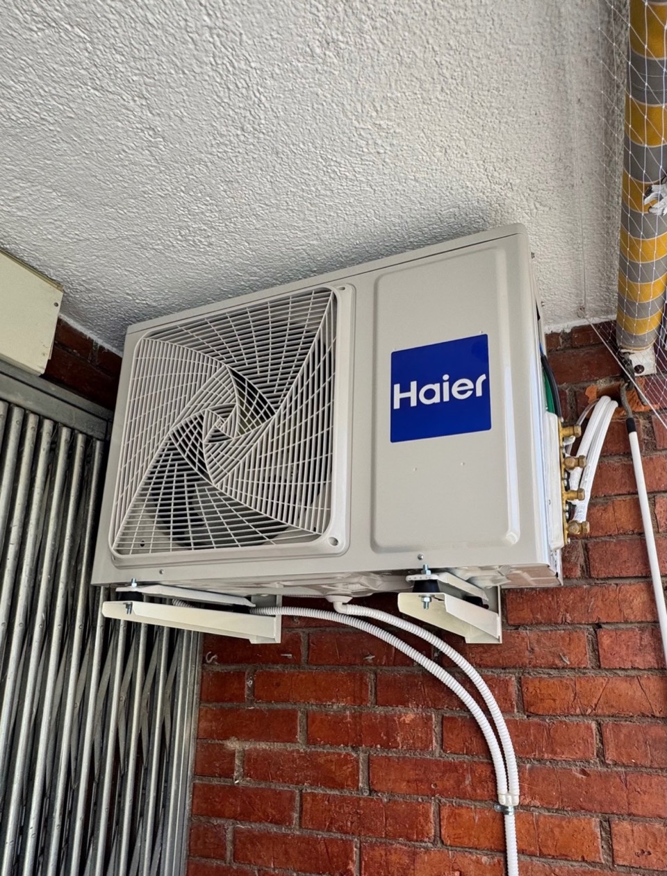 Haier outdoor unit on wall brackets